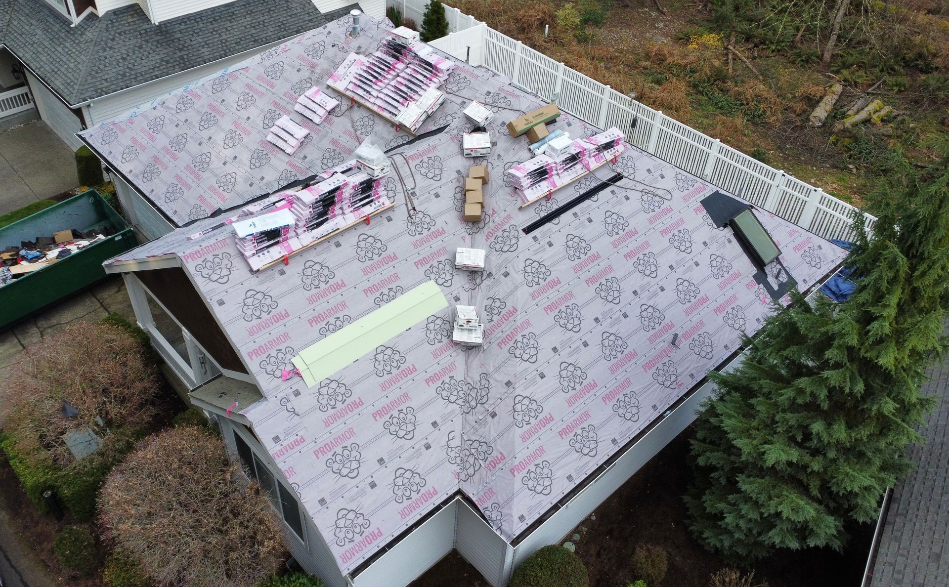 An aerial view of a house with a roof being installed.