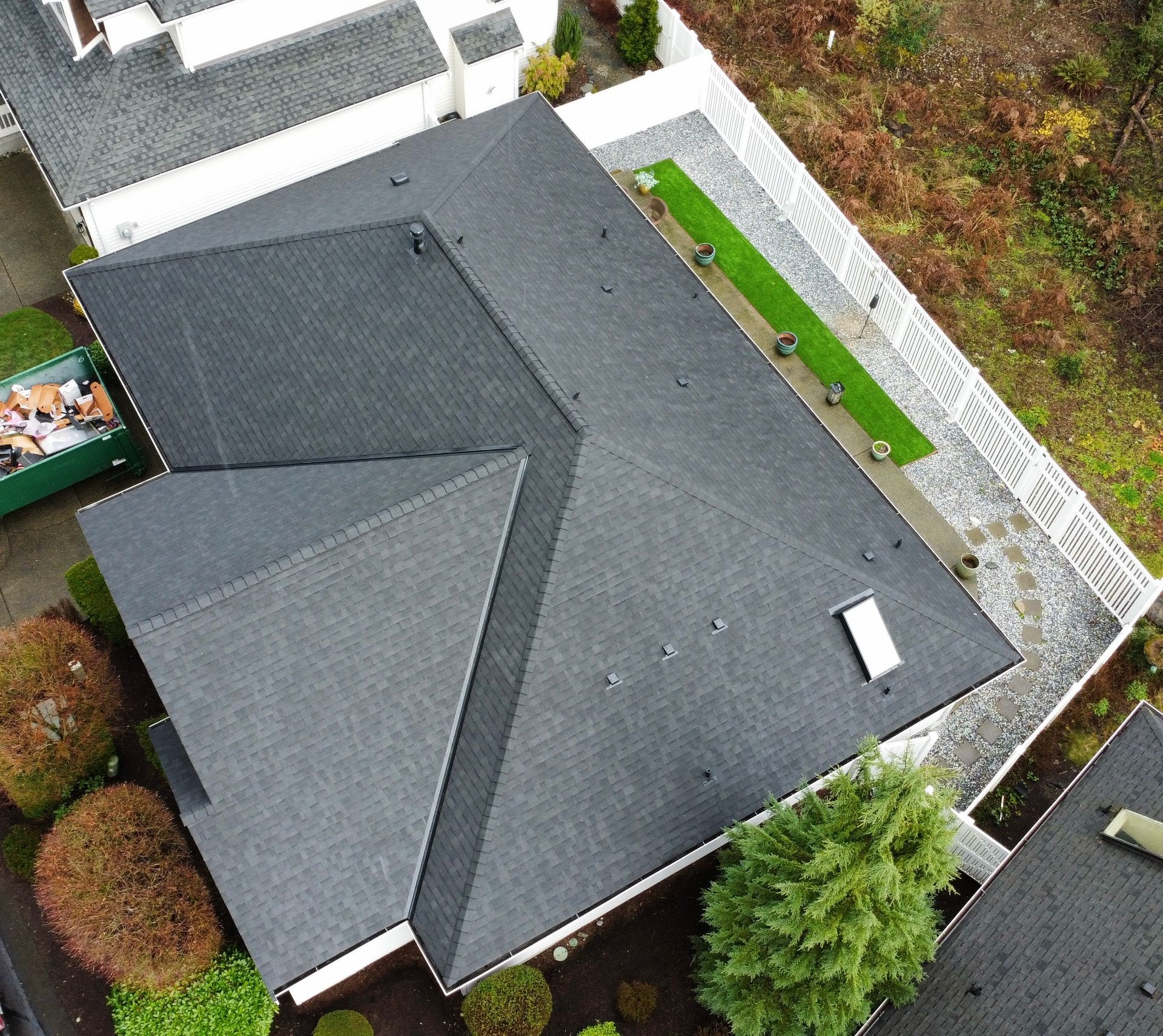 An aerial view of a house with a black roof