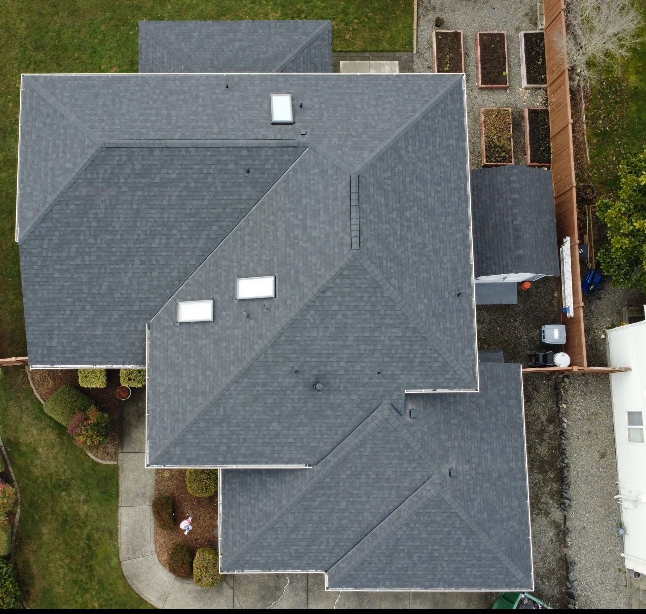 An aerial view of a house with a gray roof