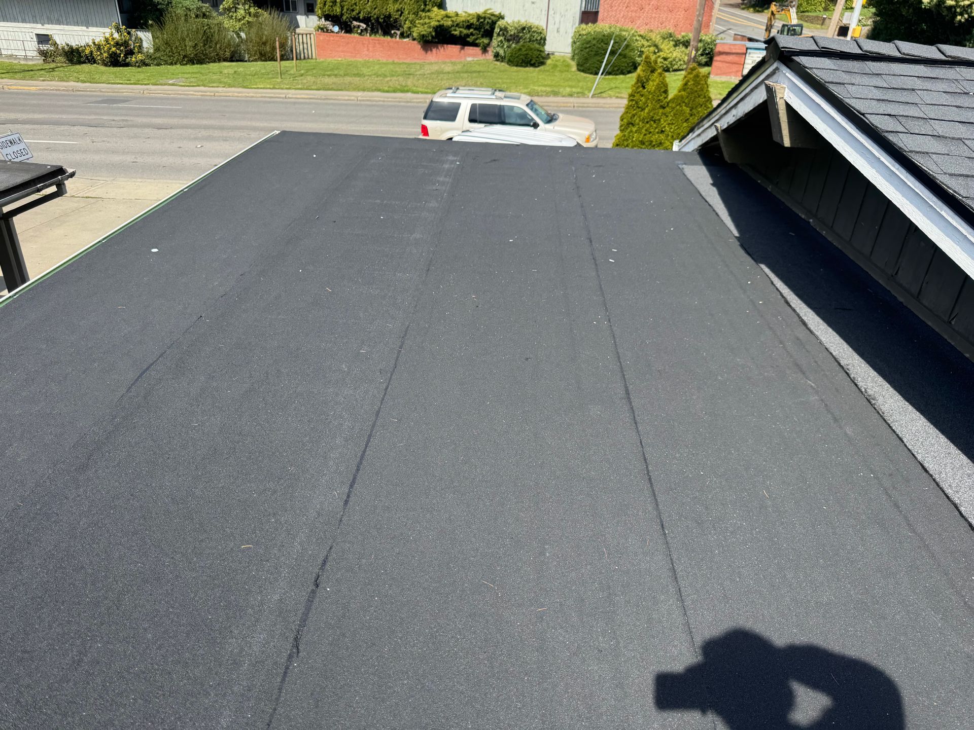 A car is parked on the roof of a house.