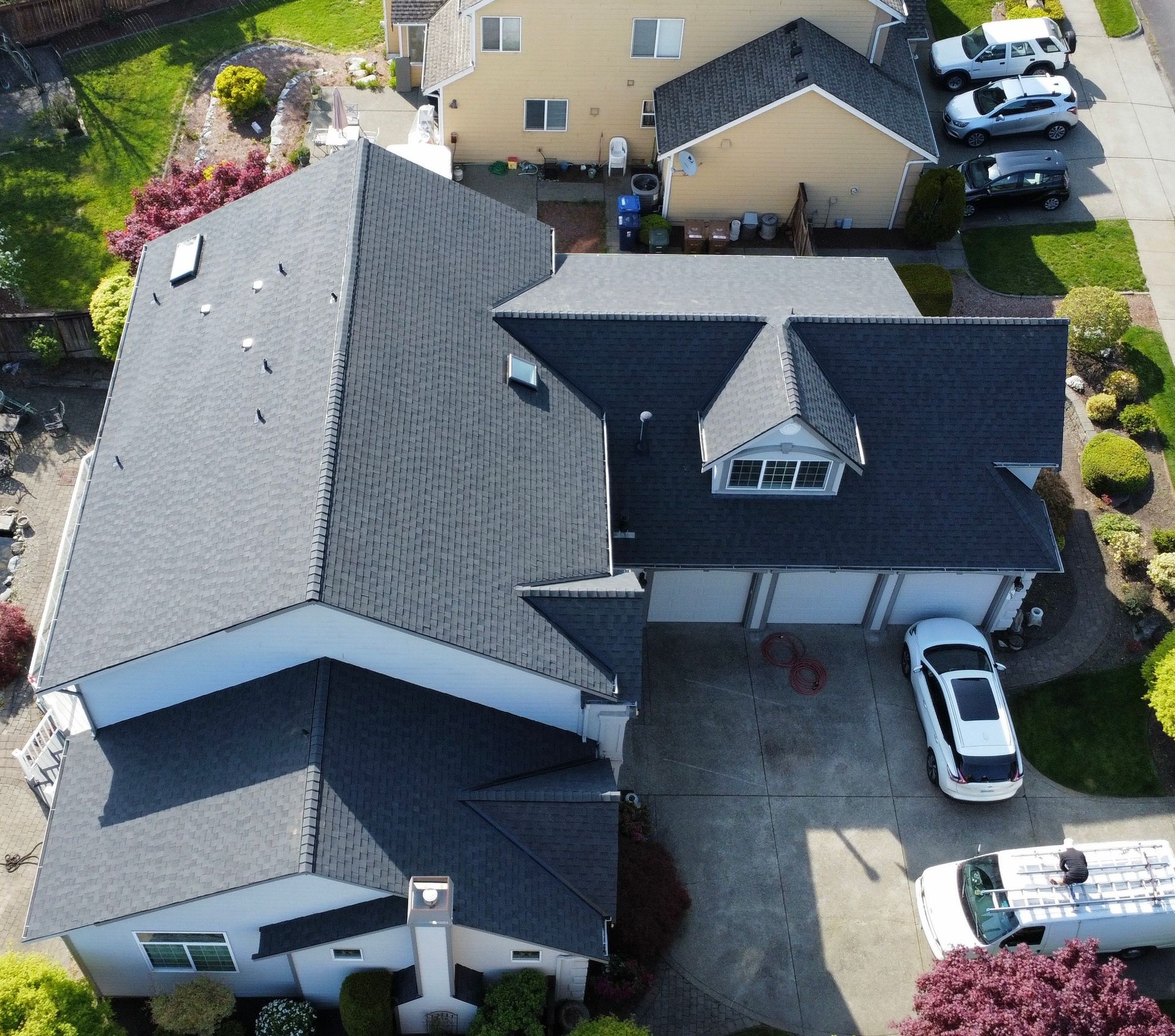An aerial view of a house with a black roof