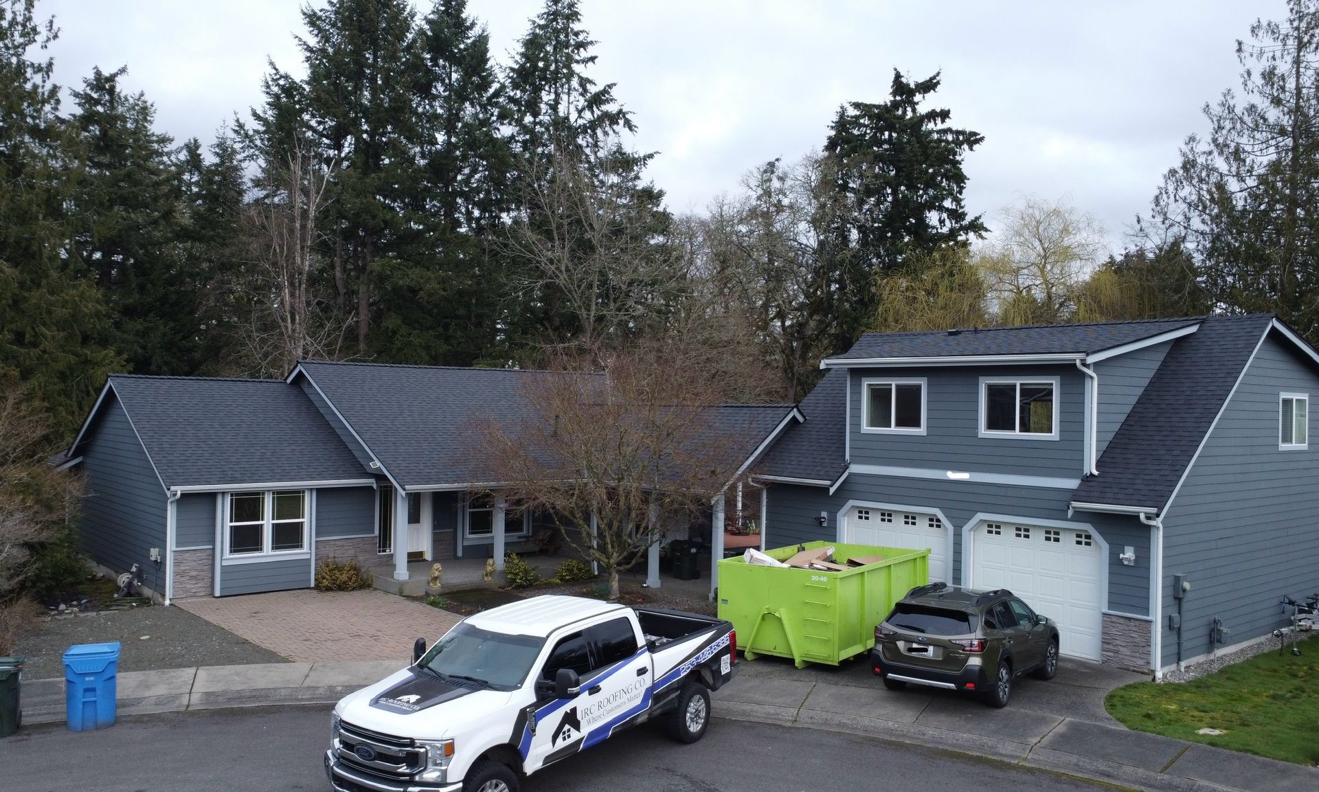 A white truck is parked in front of a house.