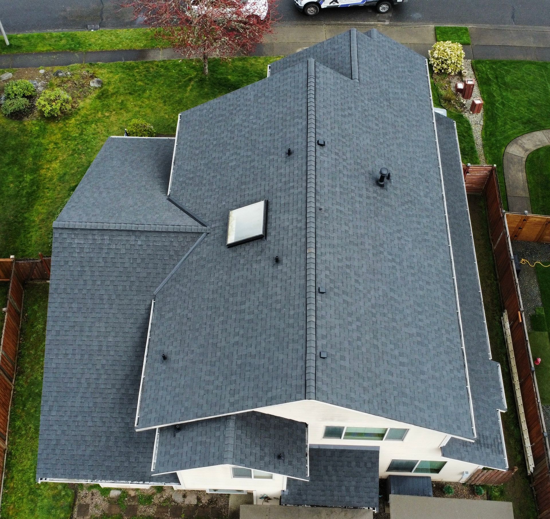 An aerial view of a large house with a gray roof.