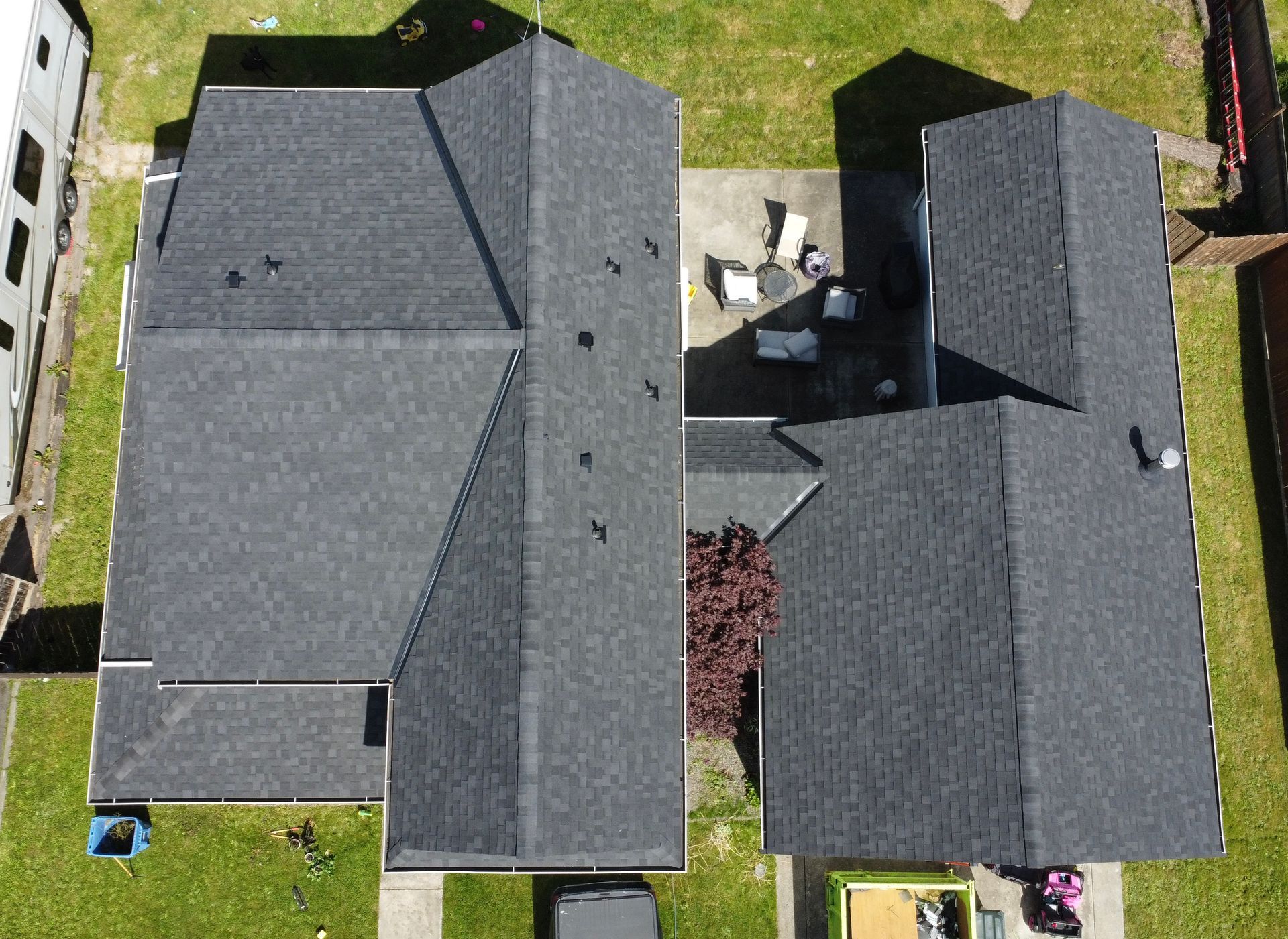 An aerial view of a house with two roofs.