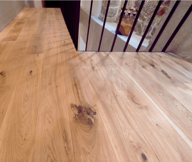 upstairs hall with light hardwood floors