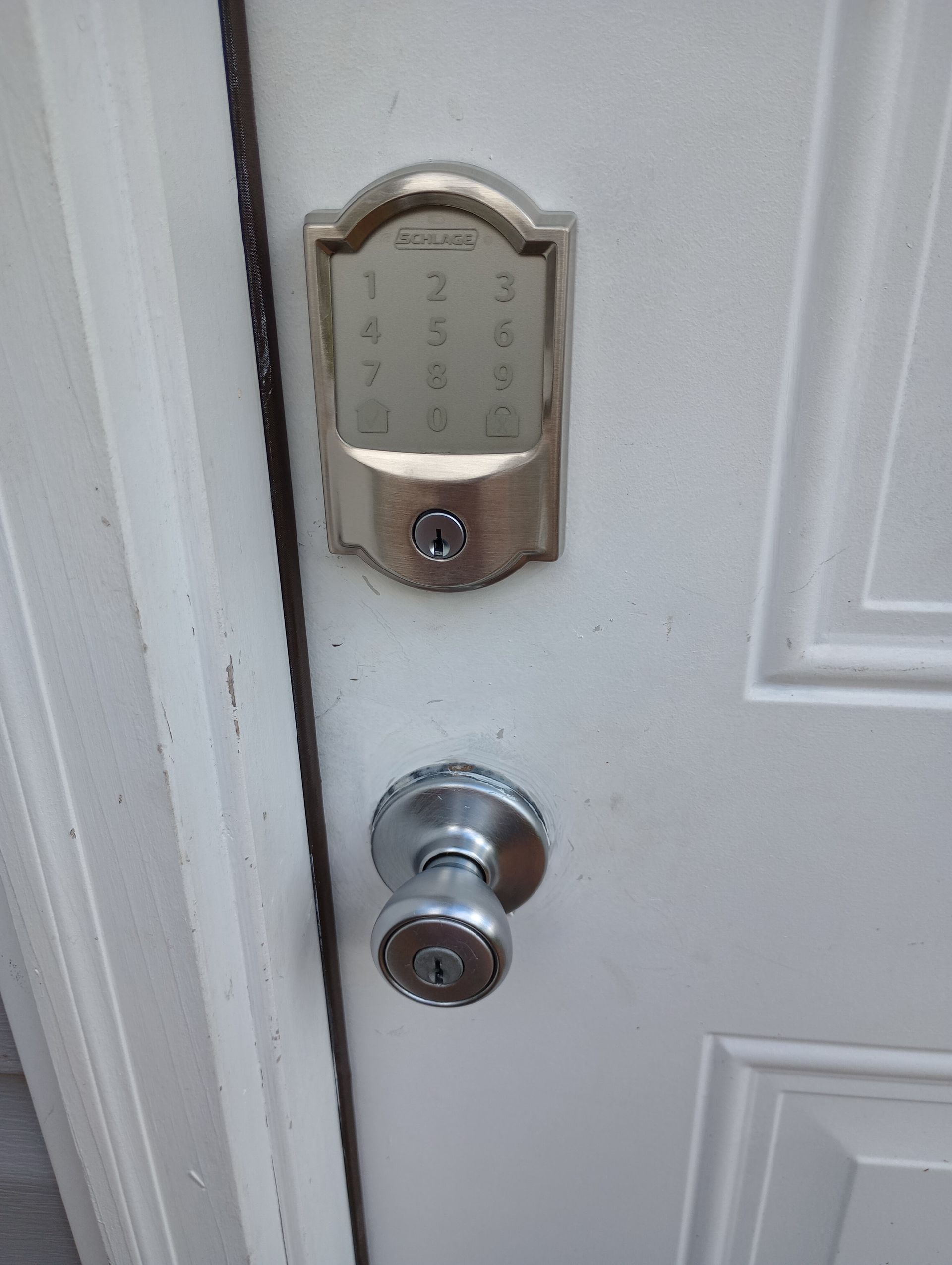 A close up of a door with a keypad on it.
