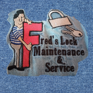 A blue sign that says call fred 's lock maint and service