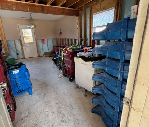 A room with a lot of tools and a stack of blue boxes.