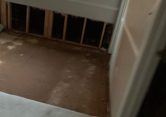 There is a hole in the wall in the corner of the room.