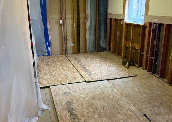 A room with a lot of wooden boards on the floor.