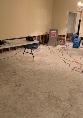 A room with a table and a vacuum cleaner in it.