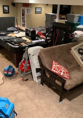 A living room filled with furniture and a pool table.