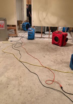 A room with a lot of wires hanging from the floor.