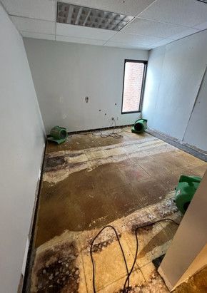 A room with a lot of water on the floor and a window.