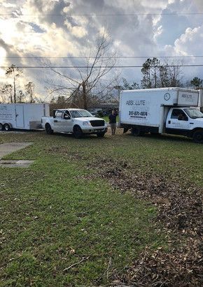 A couple of trucks parked in a grassy field.
