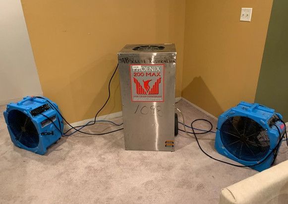 Two blue fans are sitting next to each other in a room.