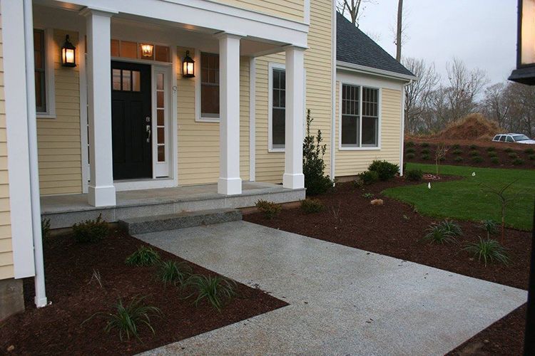 A yellow house with a black door and white trim