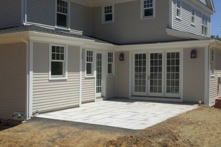 A large house with a large patio in front of it.