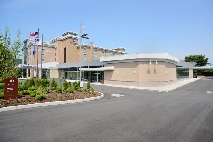 A large building with a parking lot in front of it