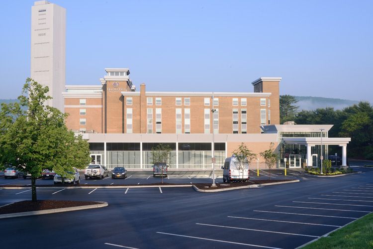 A large building with cars parked in front of it