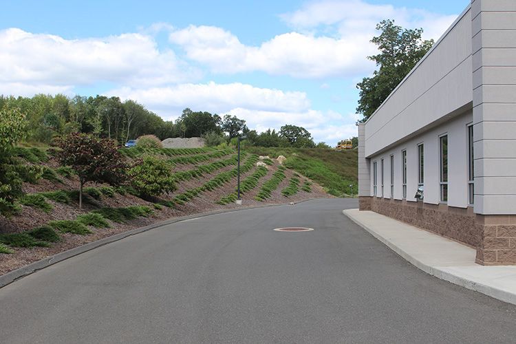 A road with a white building in the background