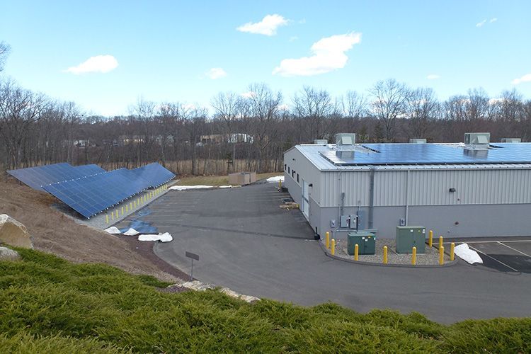 A large building with a lot of solar panels on the roof.