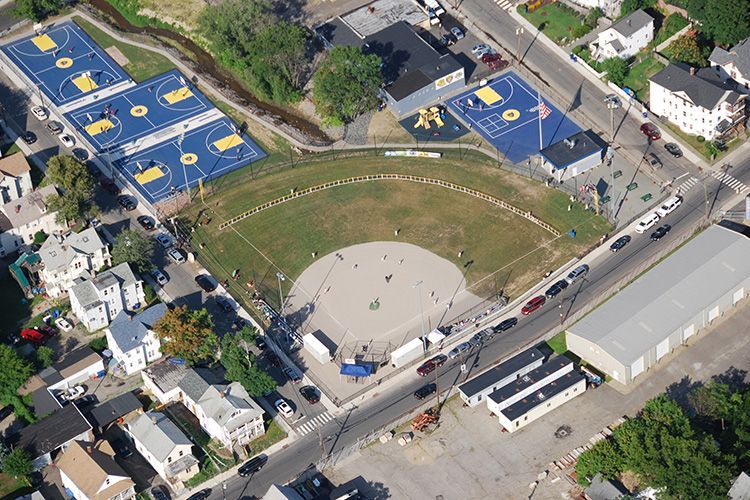 An aerial view of a baseball field and basketball courts