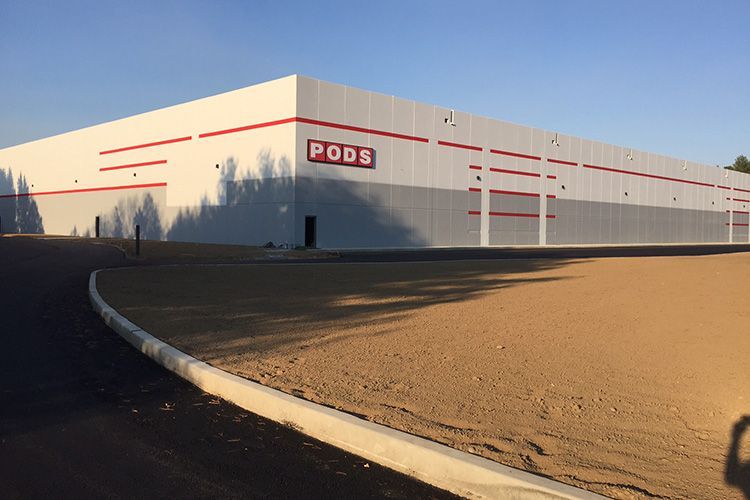 A large white building with the word pods on it