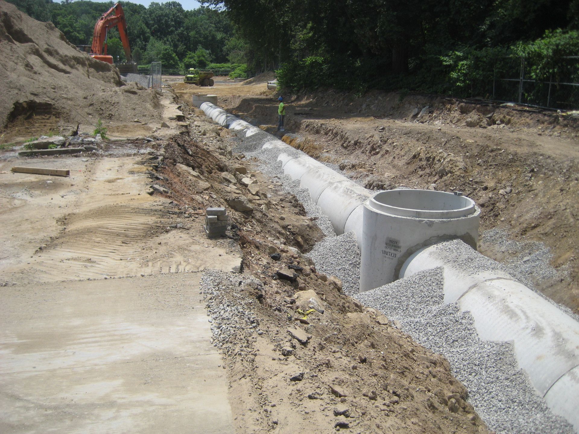 A construction site with a large excavator in the background