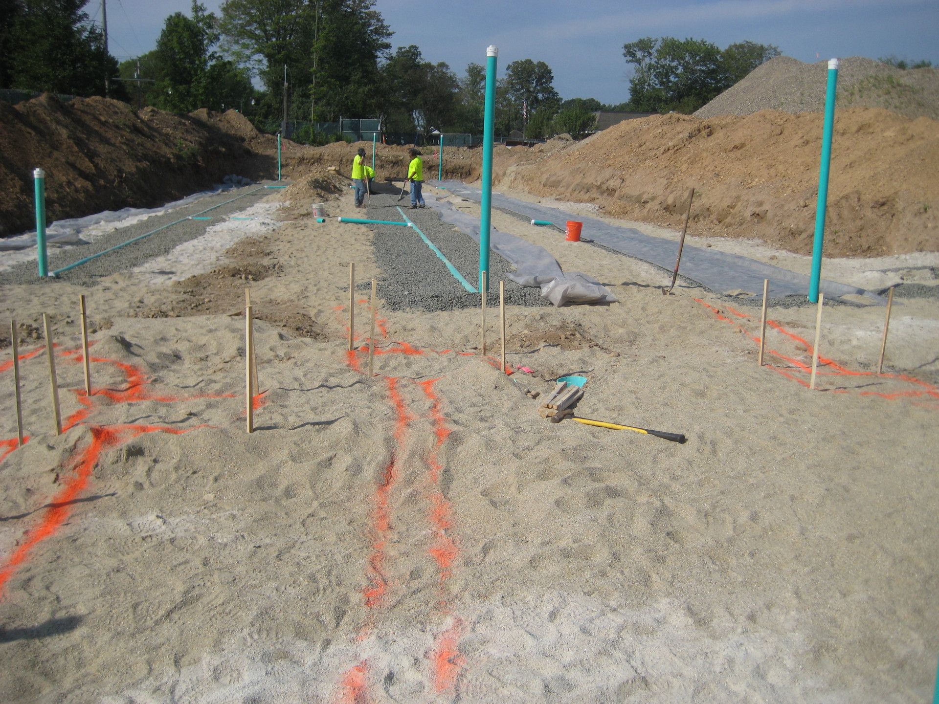 A construction site with a lot of sand and pipes