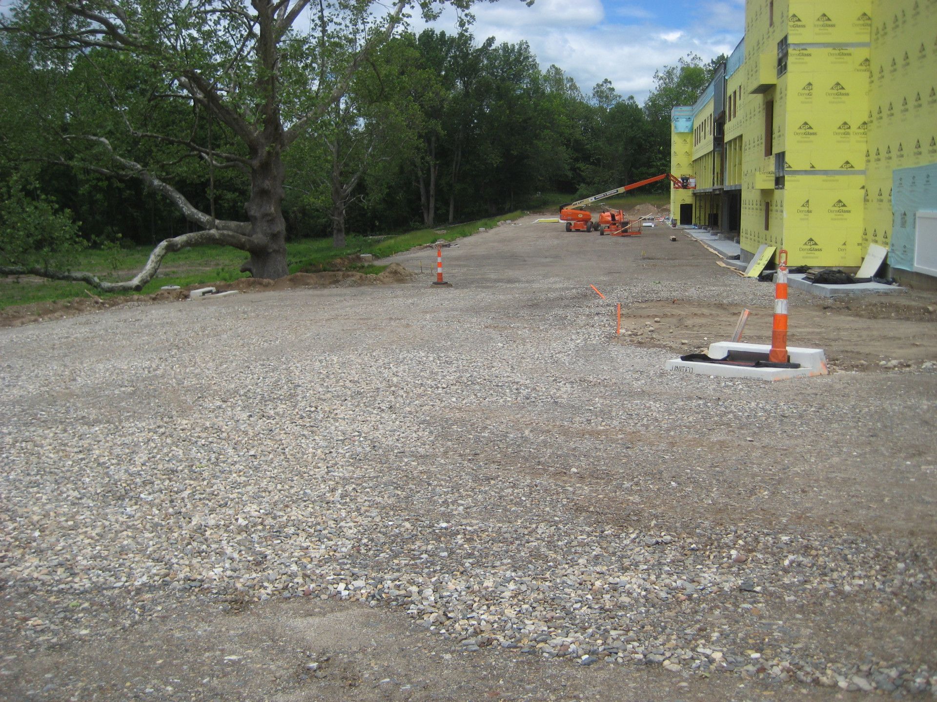 A gravel road leading to a building under construction