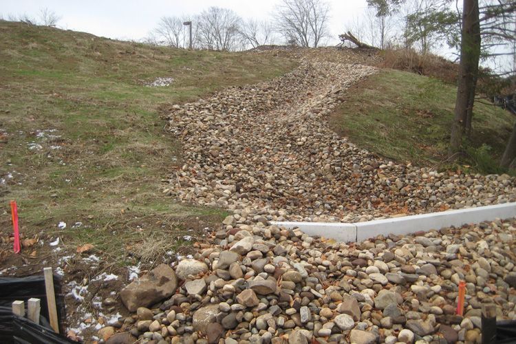 A pile of rocks is sitting on top of a grassy hill.