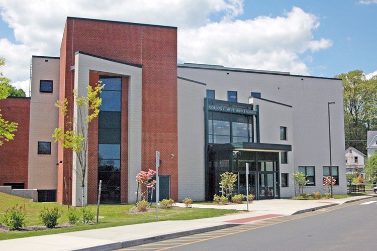 A large school building with a lot of windows.