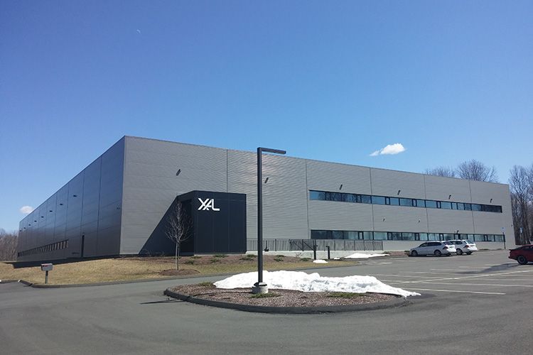 A large building with a parking lot in front of it.