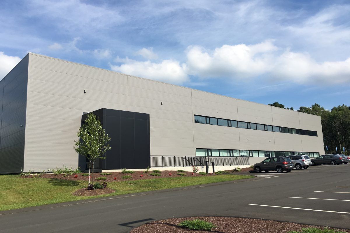 A large building with cars parked in front of it.