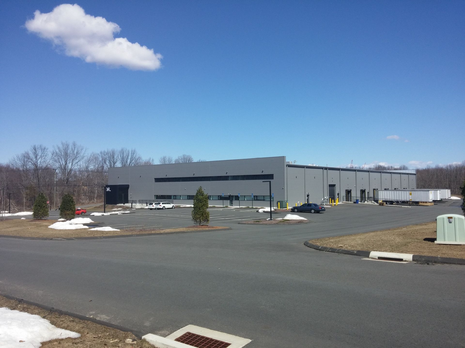 A large building with a lot of cars parked in front of it