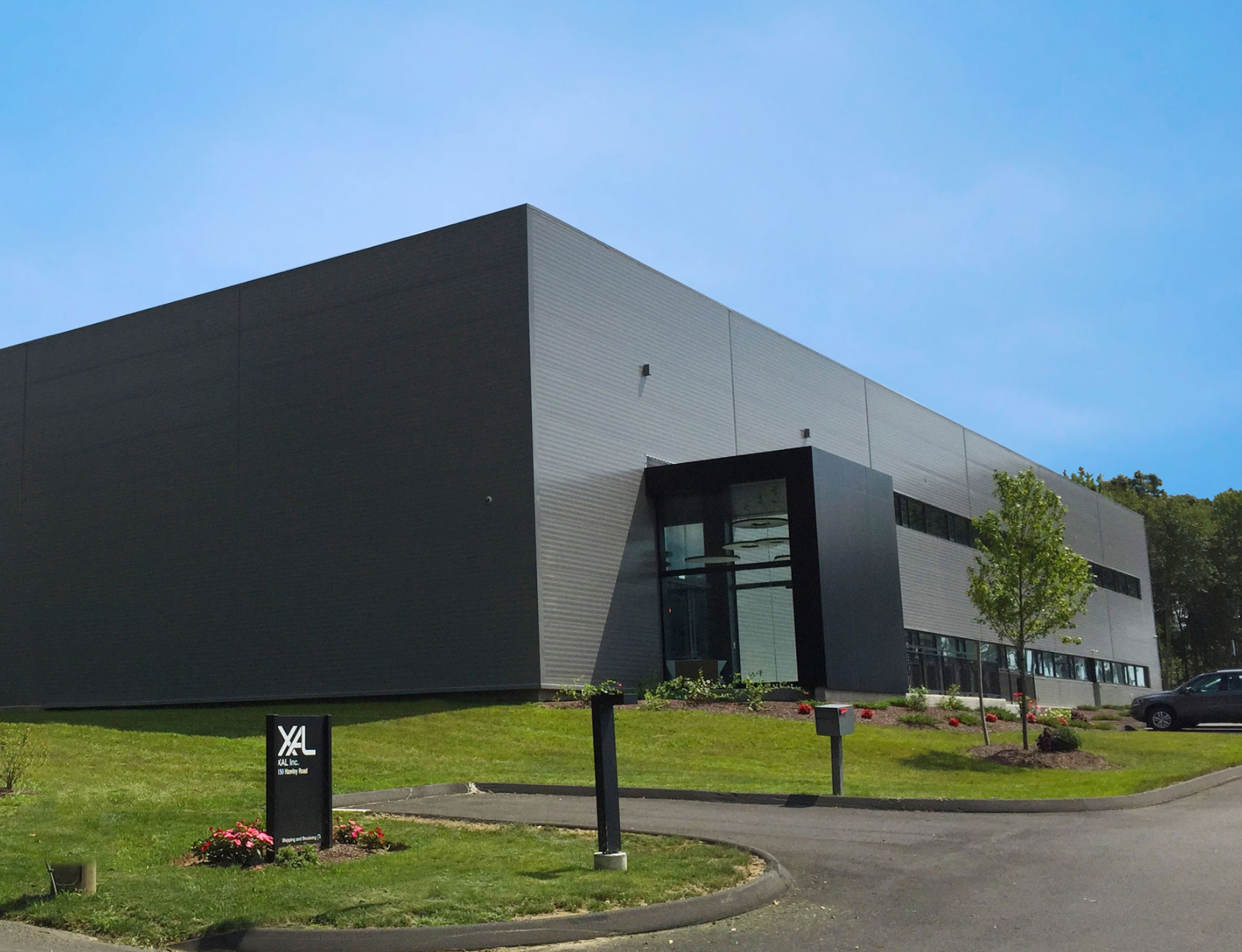 A large black building with a sign in front of it