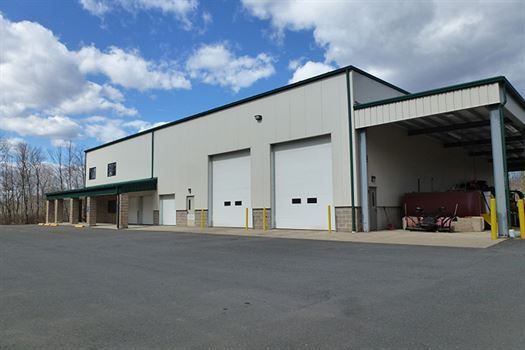 A large white building with a lot of garage doors