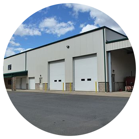 A large white building with a lot of garage doors