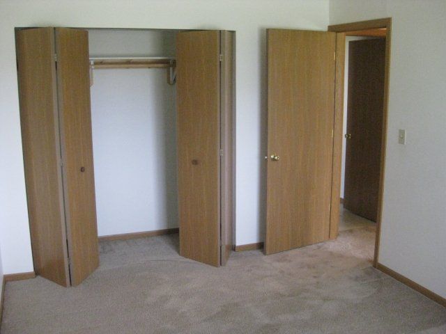 Cleora Apartments bedroom and view of an opened closet