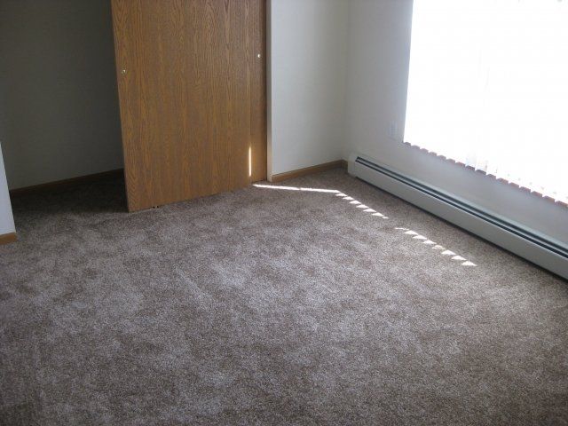 Cleora Apartments bedroom and view of an opened closet