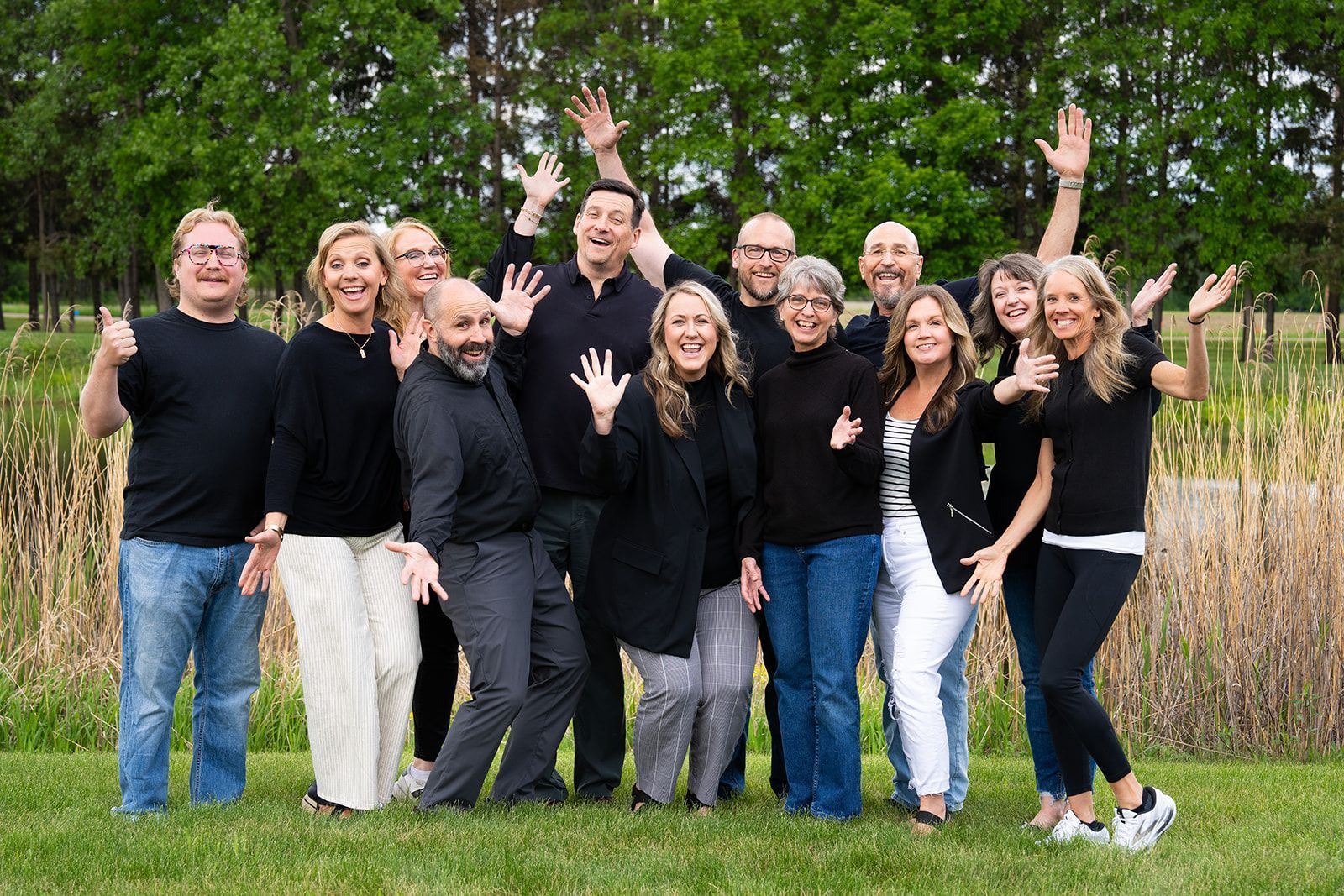 A group of people are posing for a picture in a field.