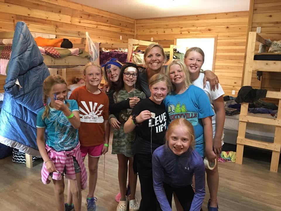 A large group of people are posing for a picture in front of a pavilion.