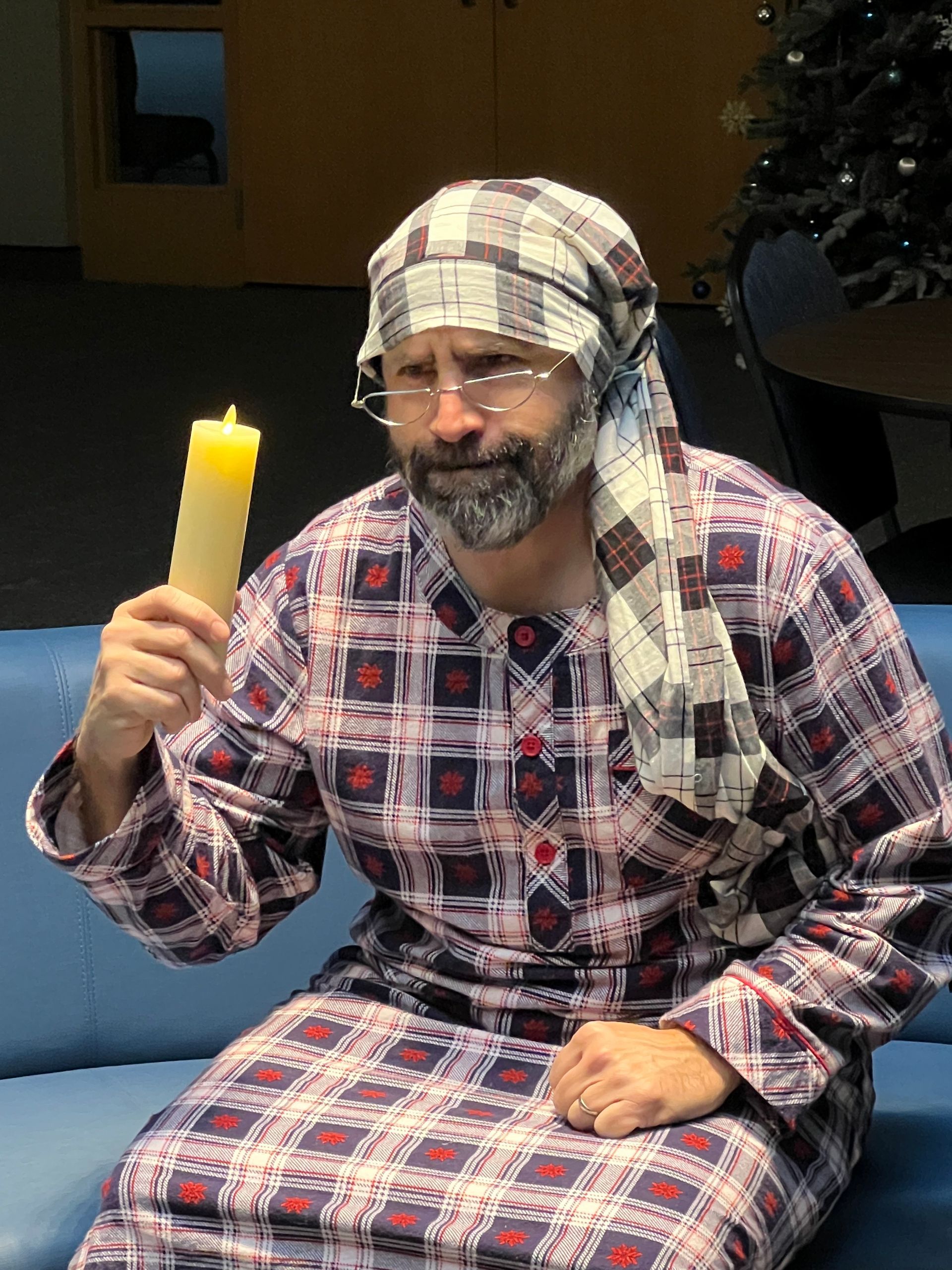 A man is kneeling down next to a little girl in a church.