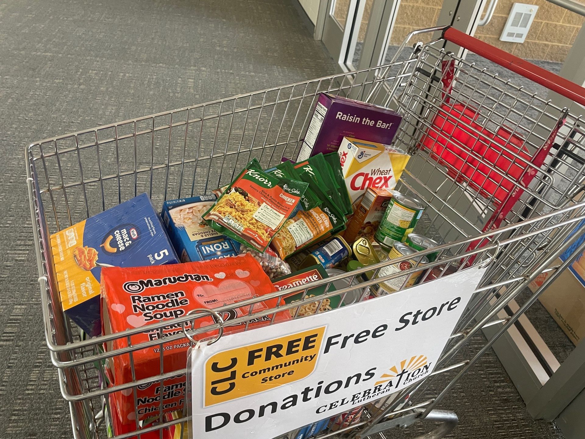A shopping cart filled with donations for a free store