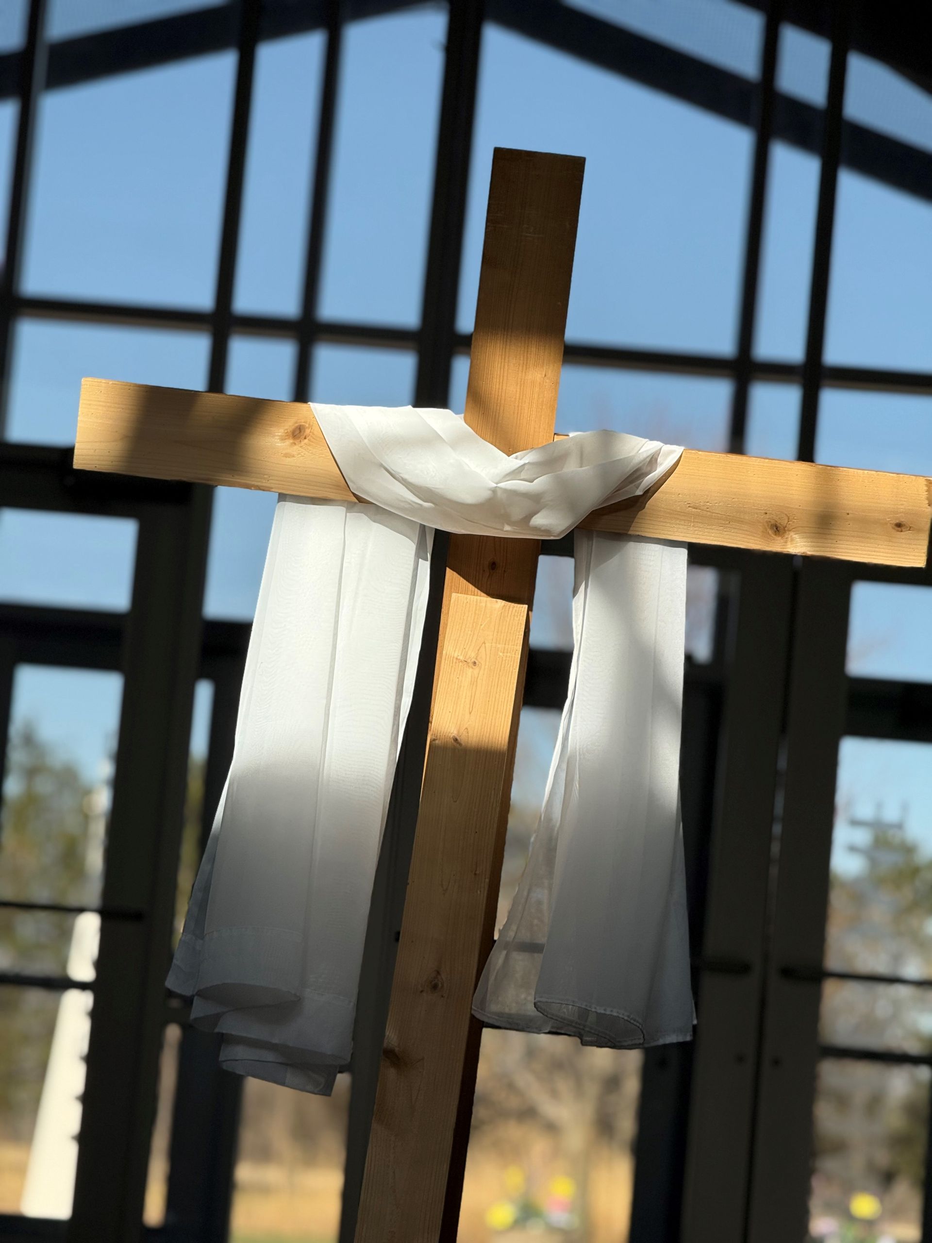 A wooden cross with a white cloth around it