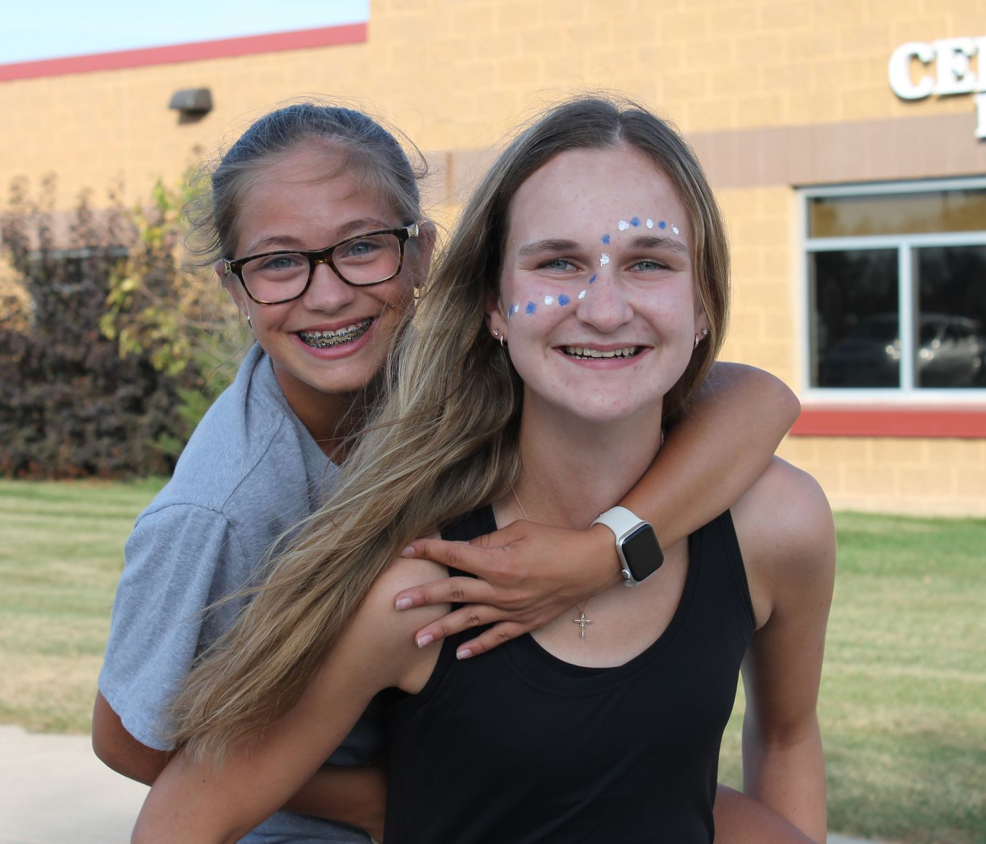 A man and a woman are standing next to each other wearing blue shirts that say celebration.