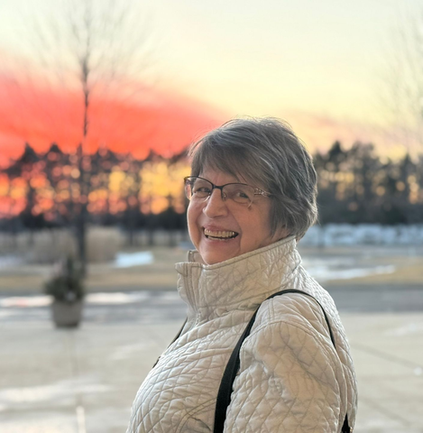 A man and a woman are standing next to each other wearing blue shirts that say celebration.