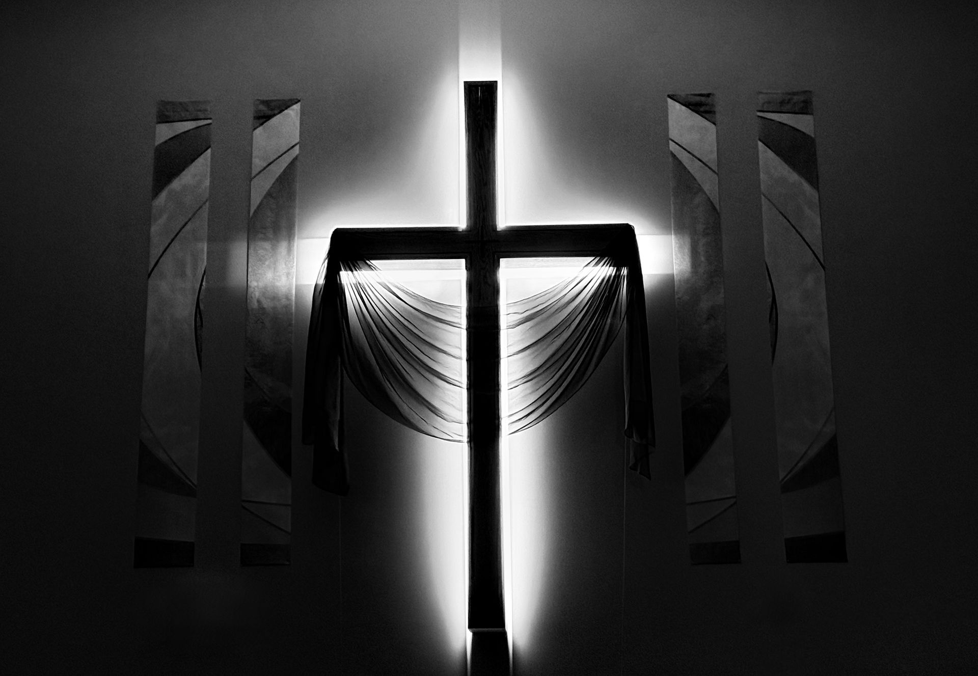 A man is kneeling down next to a little girl in a church.