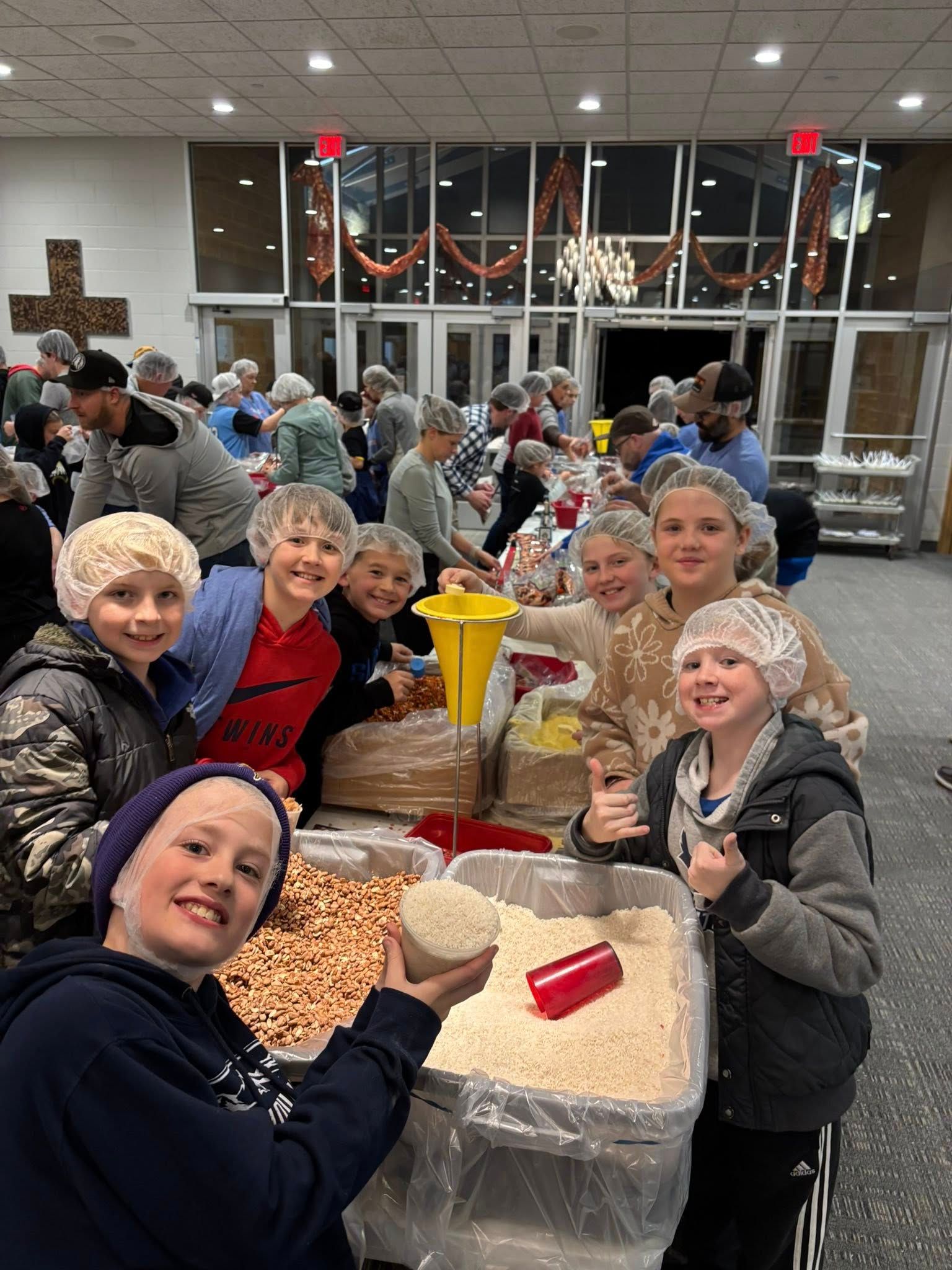 A man and a woman are standing next to each other wearing blue shirts that say celebration.